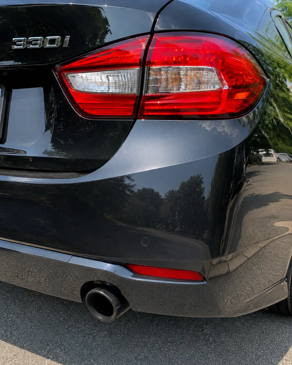 BMW 330i rear bumper dent repaired, original finish preserved in Apache Junction, AZ, after