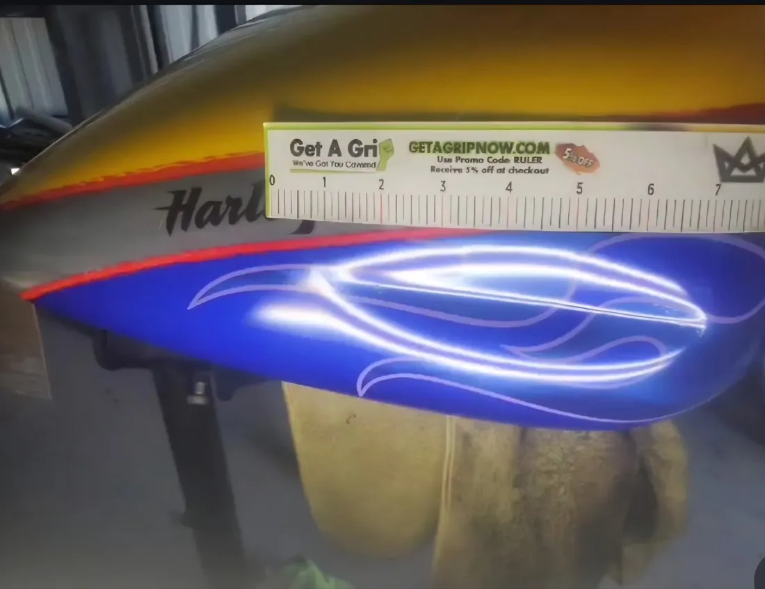 Custom flame Harley-Davidson fuel tank dent repaired with PDR, blue flame paint preserved in Apache Junction, AZ, before