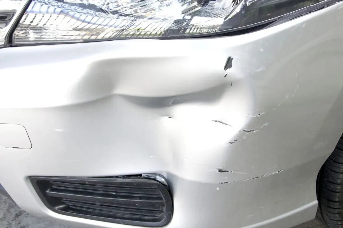Front bumper dent massaged out with PDR, no repaint needed in Mesa, AZ, before