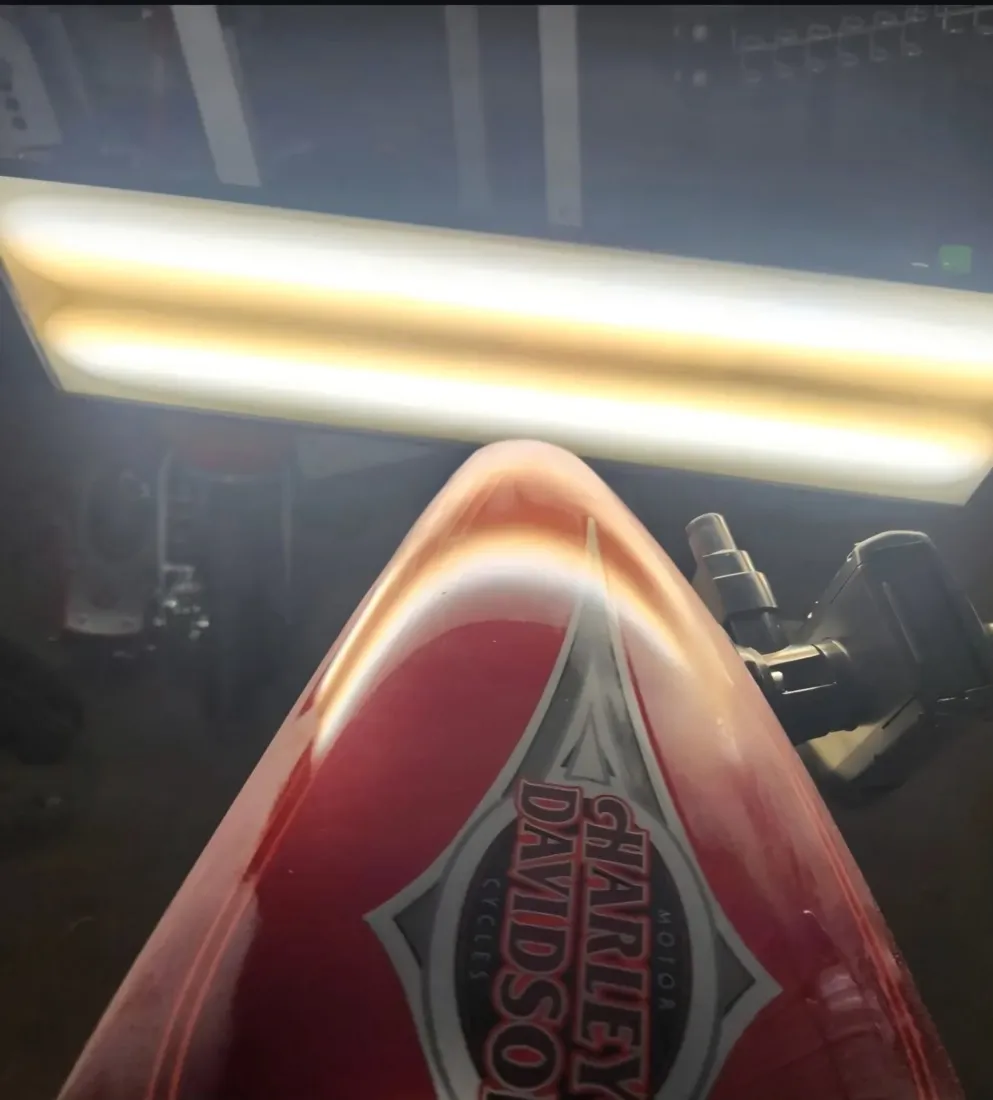 Red Harley-Davidson motorcycle tank dent removed with paintless dent repair in Apache Junction, AZ, after