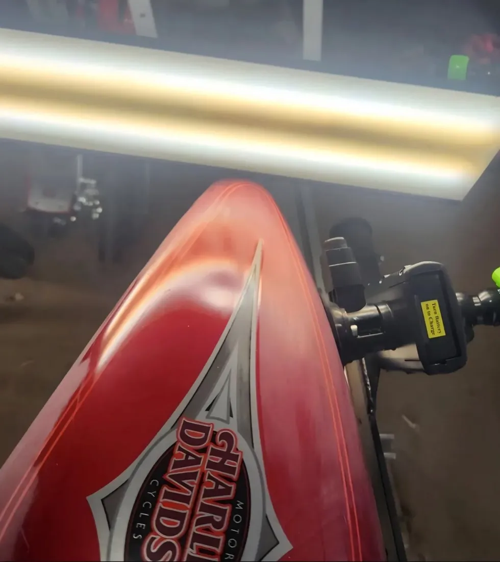 Red Harley-Davidson motorcycle tank dent removed with paintless dent repair in Apache Junction, AZ, before