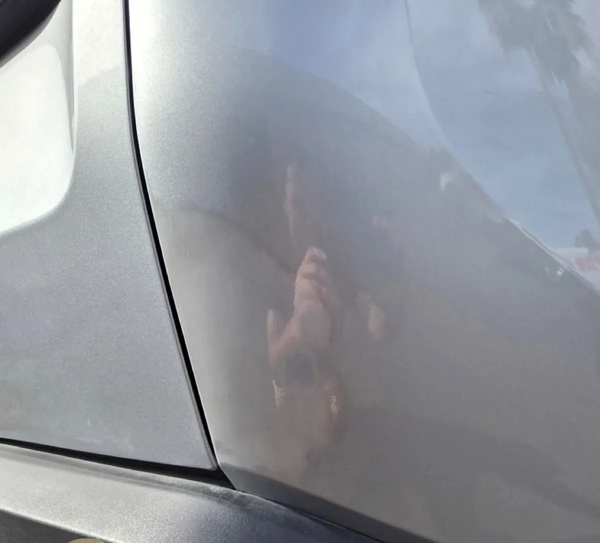Large dent by the door seam removed with paintless dent repair in Apache Junction, AZ, after
