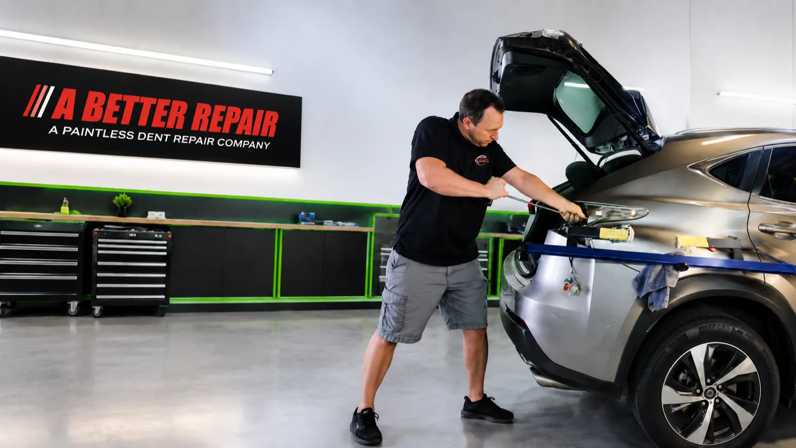 Jerod Kirk performing paintless dent repair on a truck door, Mesa Arizona