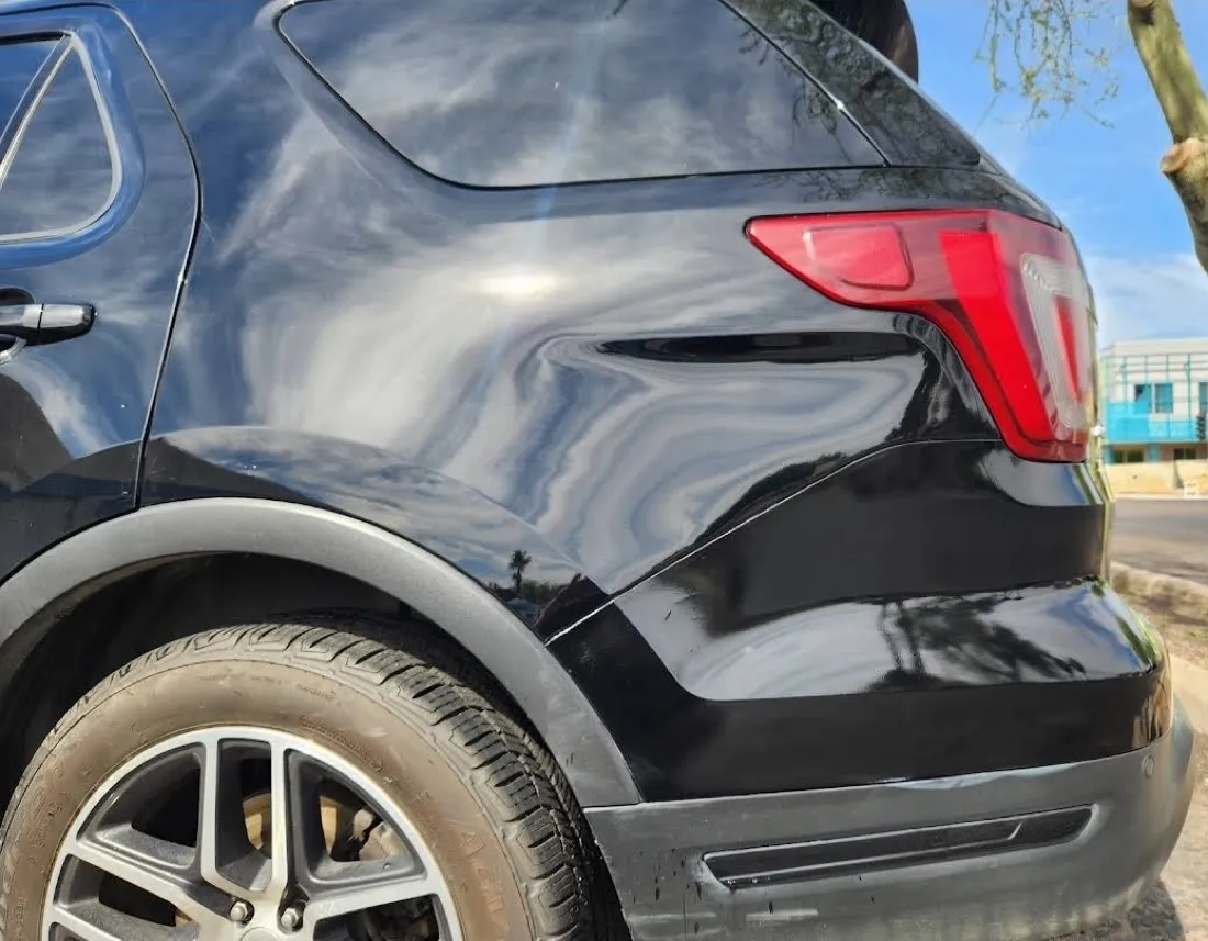 Dent on an SUV rear quarter panel removed with paintless dent repair in Apache Junction, AZ, before